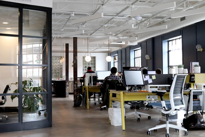 shot of modern office with employees working at desks