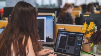 girl using illustrator on laptop