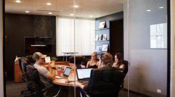 people around table having meeting in conference room