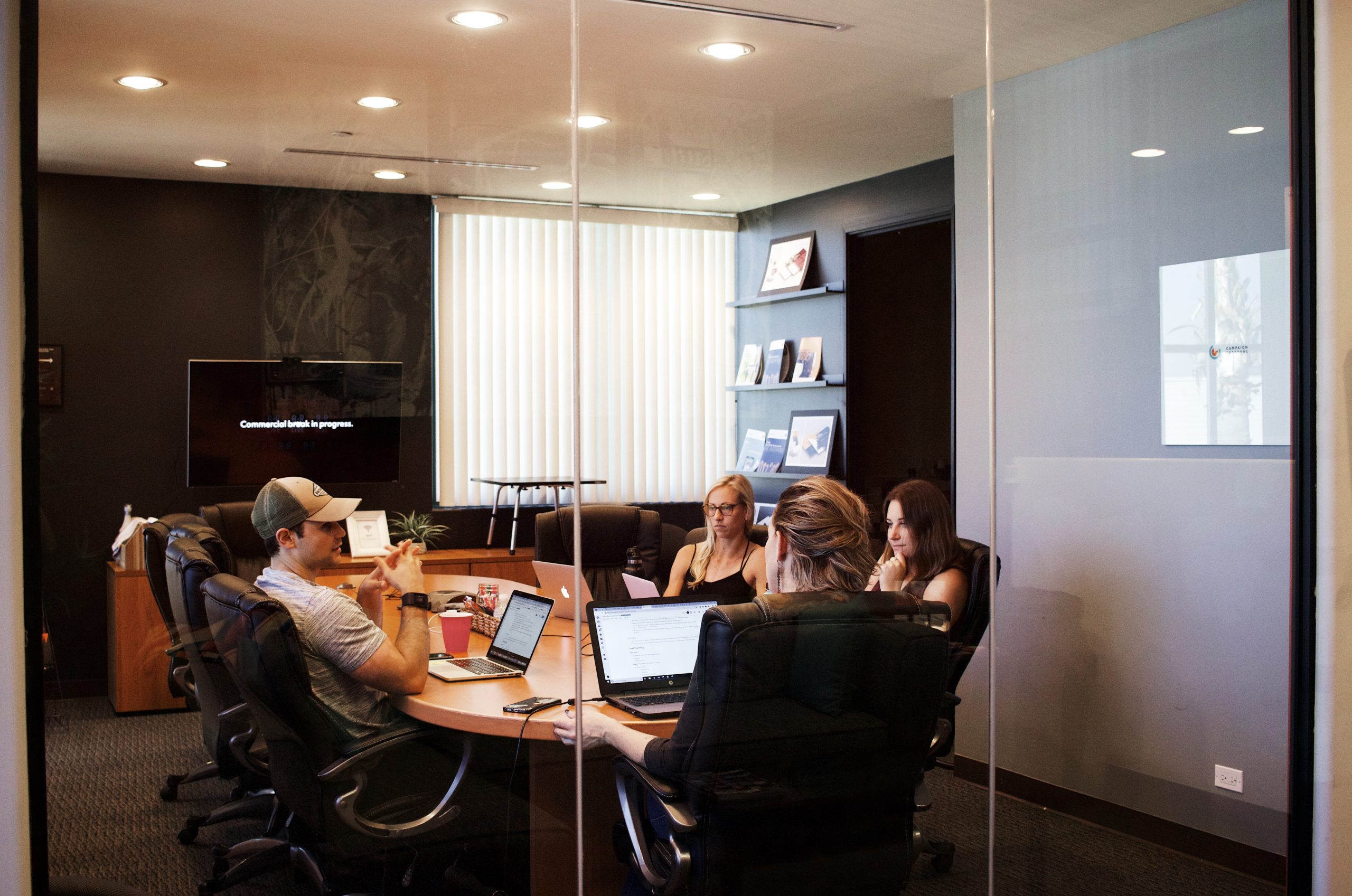 people around table having meeting in conference room