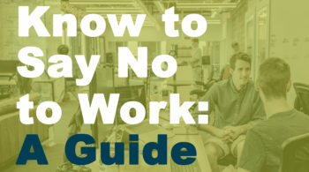 men in workplace in front of desktops talking