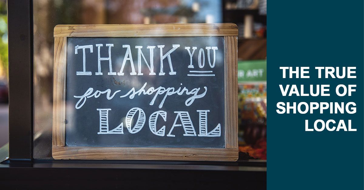 chalkboard behind window that reads "thank you for shopping local"