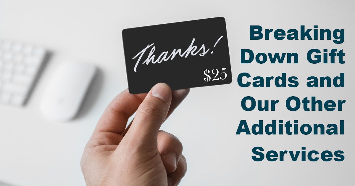 Hand holding up a twenty five dollar gift card that says "thanks"