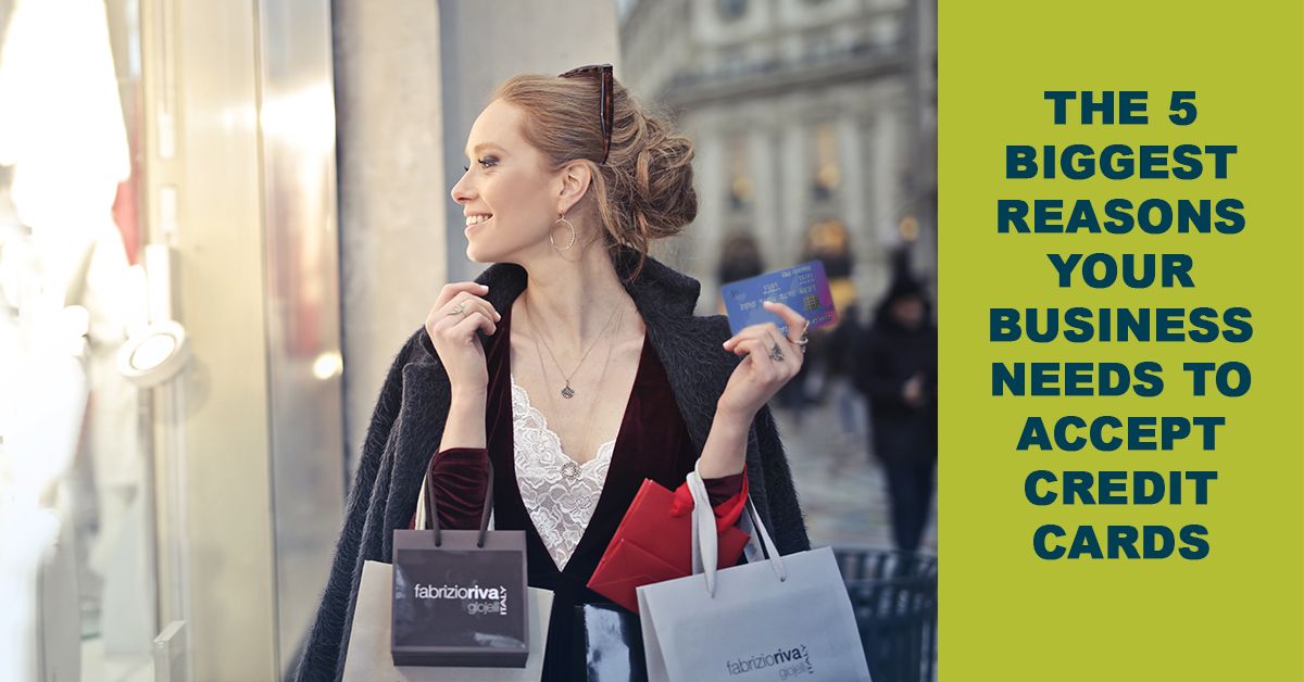 woman with shopping bags in arms window shopping